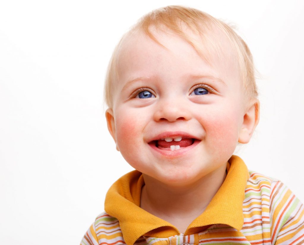 Baby showcasing tooth eruption