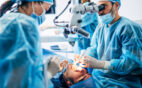 A team of dental surgeons performing a tooth removal surgery.