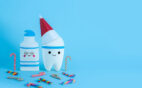 A tooth and toothpaste designed to be festive for the holidays to represent dental hygiene routines after the new year.